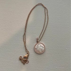 Gold Mary pendant, a little bit of discoloration.